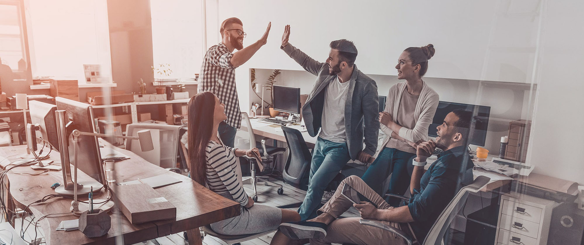 IT Referenzen, eine feiernde Gruppe Menschen im Büro